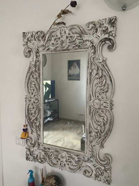 Specchio con cornice decorata in legno