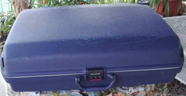 Valigia Rigida SAMSONITE  originale, colore blu, due ruote e un maniglione.